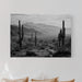 Bedroom with a large wall art print of a desert landscape featuring cacti.