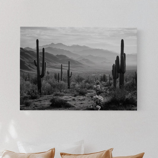 Bedroom with a large wall art print of a desert landscape featuring cacti.