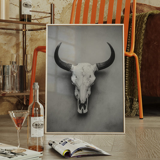 Living room with a framed picture of a bull skull, a leather sofa, and a bar area.