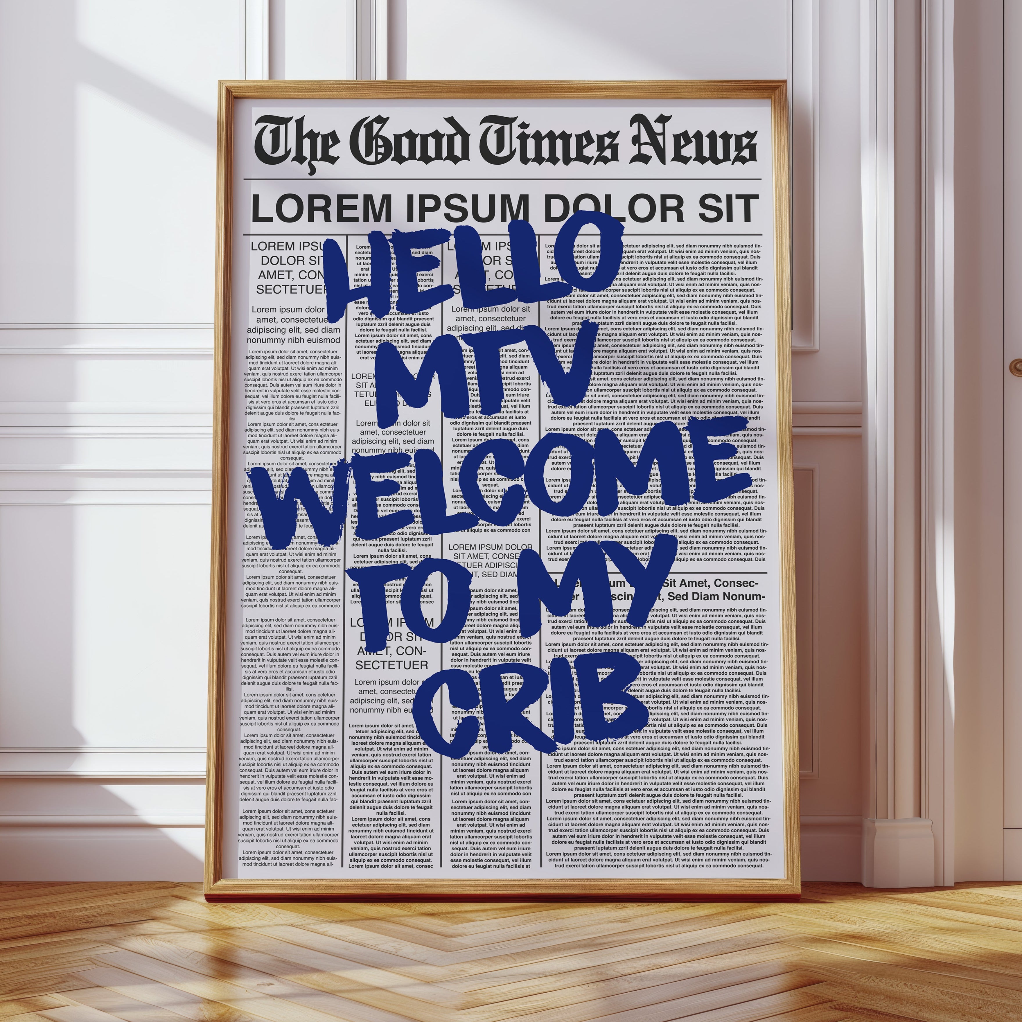 Framed newspaper with 'Hello MTV Welcome to my Crib' text in a room with wooden floor and white walls.