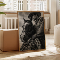 Framed black and white portrait of a man and horse in a living room.