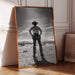 Framed black and white photograph of a cowboy in a desert landscape on a wooden floor.