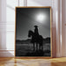 Framed black and white artwork of a silhouette of a person on horseback against a sunset.