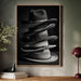 Framed artwork of stacked hats on a wall above a wooden console table.