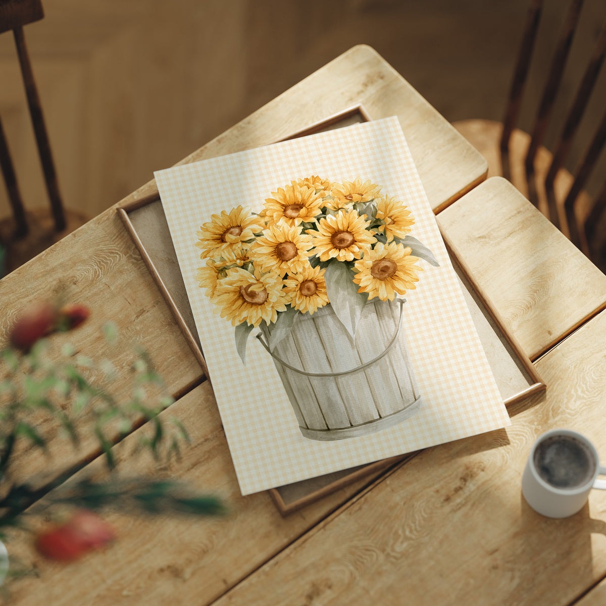 A Bucket of Sunlight Kept Indoors, a bouquet of yellow sunflowers and small blooms in a white metal pail, painted on a fine grid ground in gold, cream and sage, lying flat on a light wood table beside a coffee cup and red berries