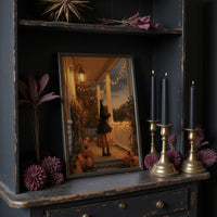 A Lantern for the Little Witch, a little witch in a pointed hat standing among pumpkins beneath string lights and a warm lantern glow, painted in orange, plum and deep shadow, on a dark wooden cabinet shelf with candles and dried flowers