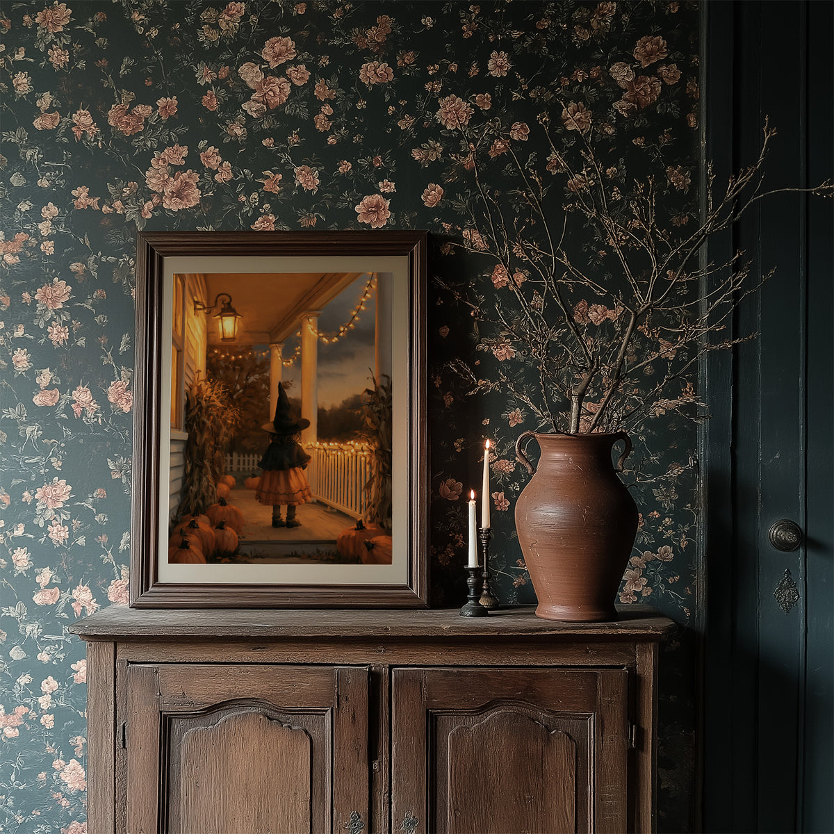 A Lantern for the Little Witch, a little witch in a pointed hat standing among pumpkins beneath string lights and a warm lantern glow, painted in orange, plum and deep shadow, in a dark frame on a wooden dresser against floral wallpaper
