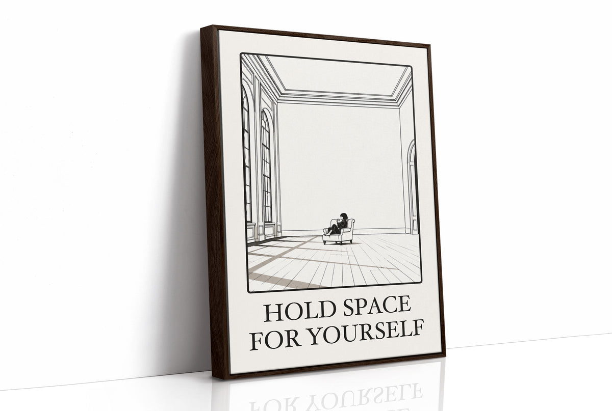 A Room Kept Open for You, a fine black line drawing of a tall empty room with a long floor, a pale window and a small seated figure, with the serif words HOLD SPACE and FOR YOURSELF beneath it on a cream ground, as a framed canvas in a brown frame