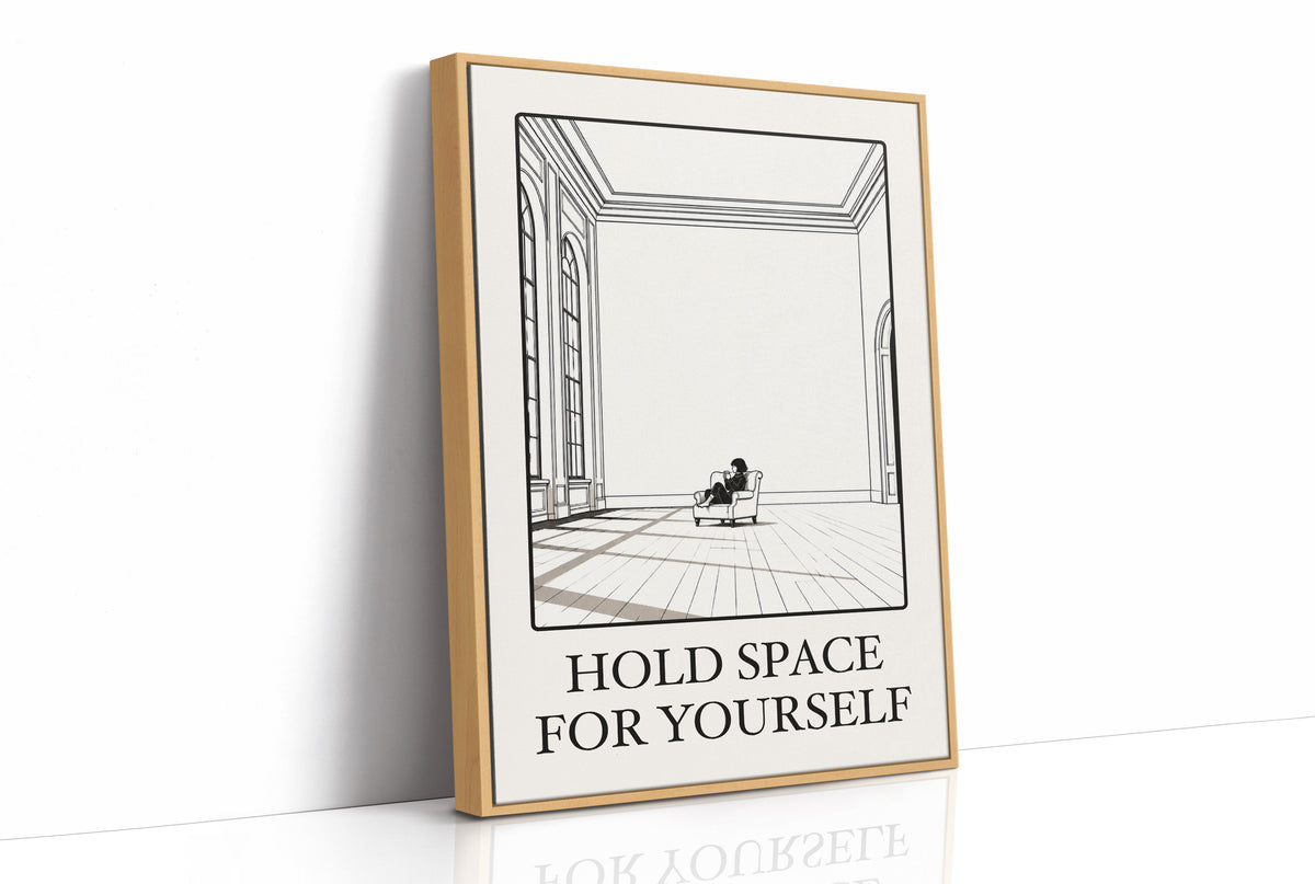 A Room Kept Open for You, a fine black line drawing of a tall empty room with a long floor, a pale window and a small seated figure, with the serif words HOLD SPACE and FOR YOURSELF beneath it on a cream ground, as a framed canvas in a natural wood frame