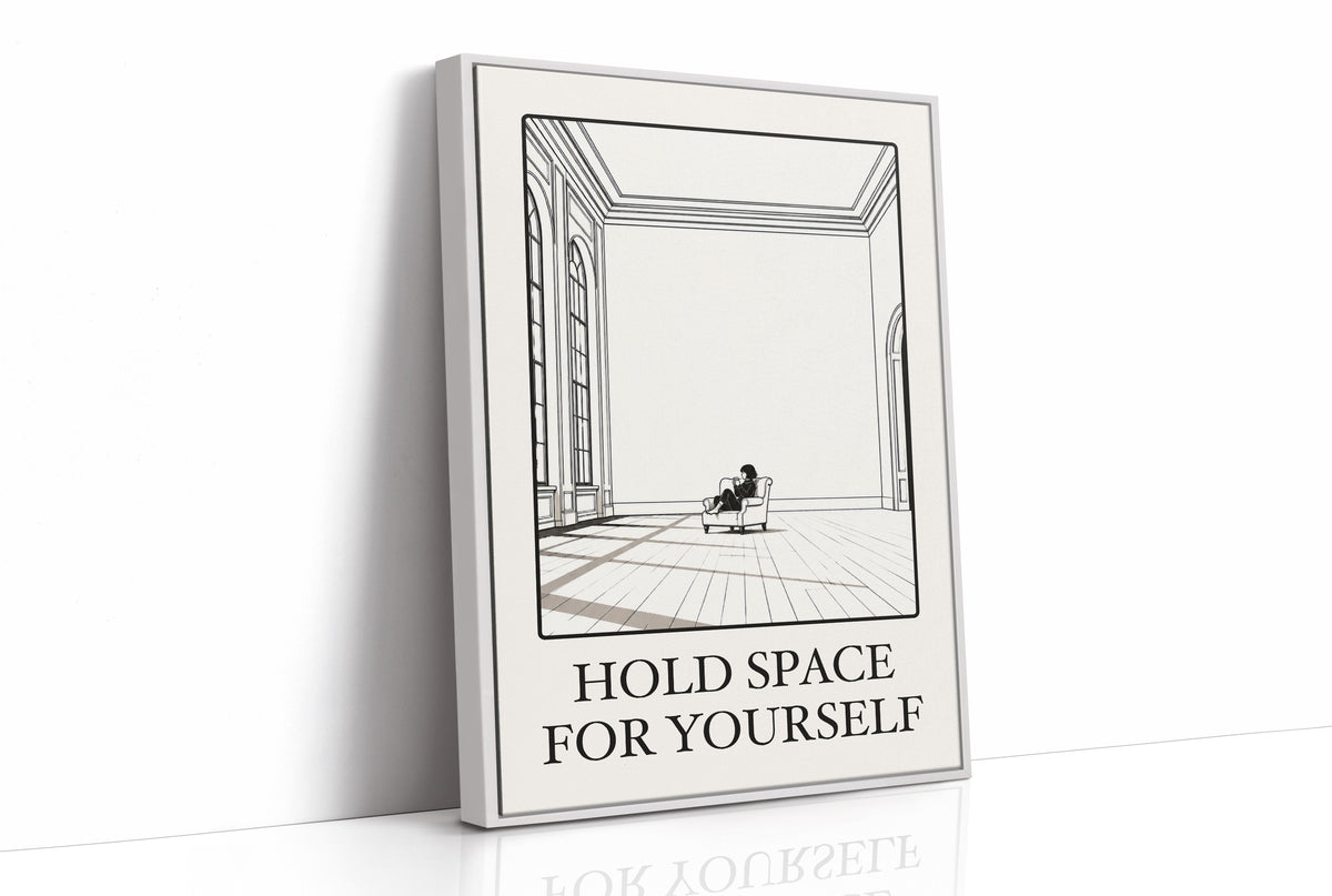 A Room Kept Open for You, a fine black line drawing of a tall empty room with a long floor, a pale window and a small seated figure, with the serif words HOLD SPACE and FOR YOURSELF beneath it on a cream ground, as a framed canvas in a white frame