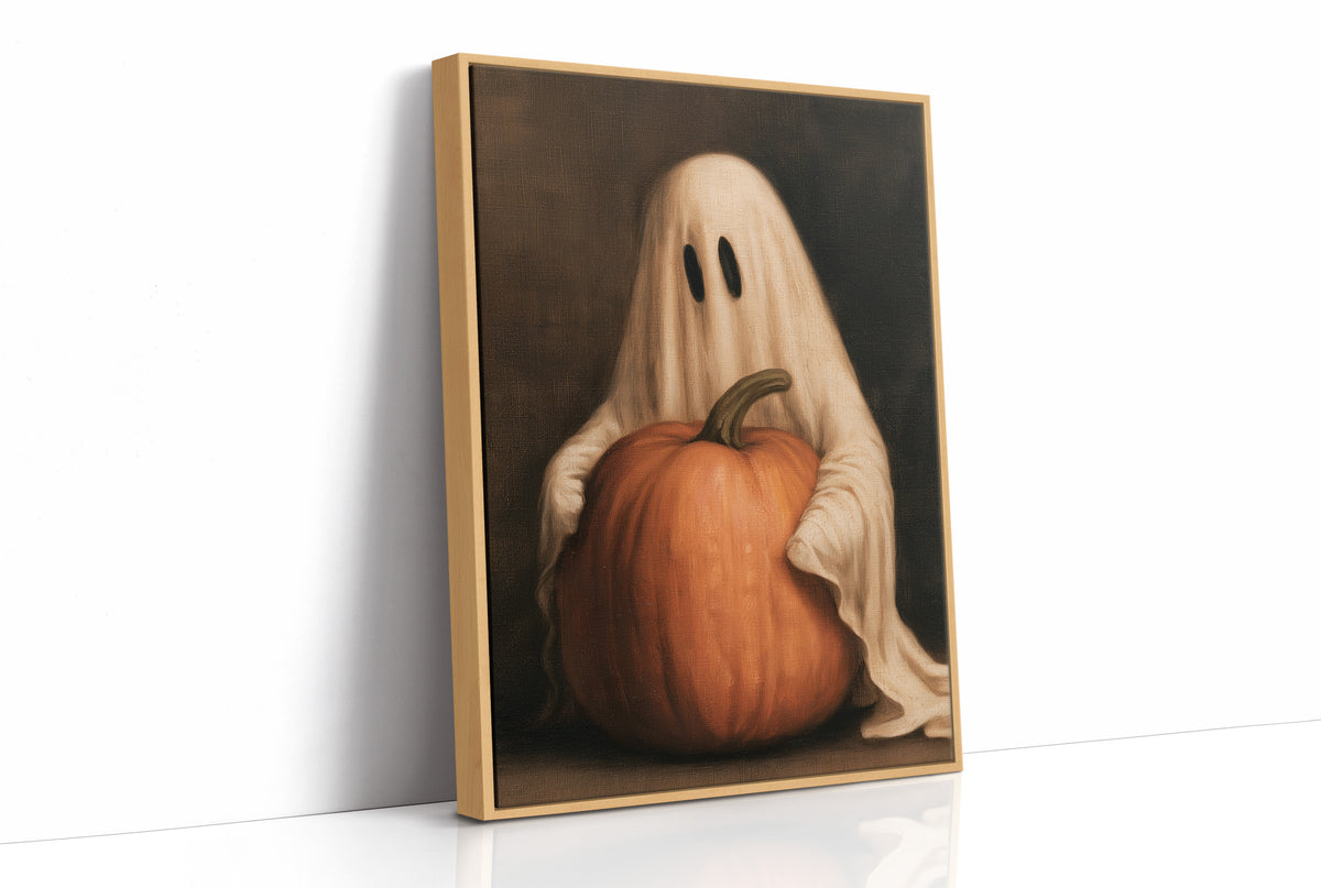A Sheet Holds the Pumpkin Still, a pale draped figure holding a large orange pumpkin close, in a dark brown painted frame with a warm glow, as a framed canvas in a natural wood frame