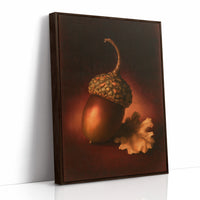 A Single Acorn in Candlelight, one acorn resting beside a curled oak leaf on a dark brown ground, lit from one side and painted in chestnut, amber and deep shadow, as a framed canvas in a brown frame