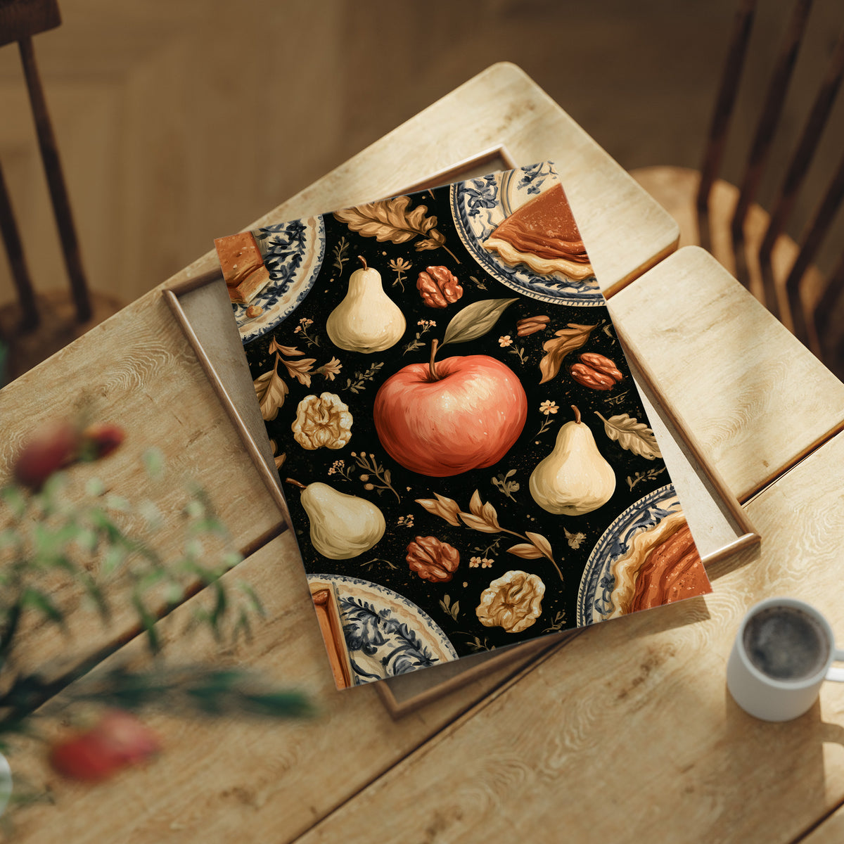 A Table Laid Before Dusk, a dark still life pattern of red apples, pale pears, walnuts and autumn leaves around pie plates, painted in charcoal, cream and rust, lying flat on a light wood table beside a coffee cup and red berries
