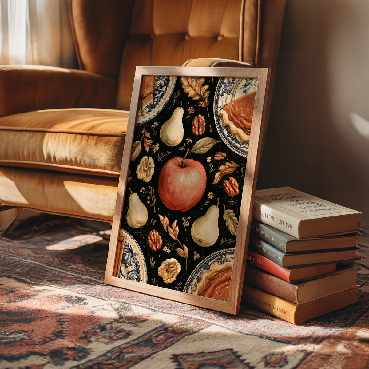 A Table Laid Before Dusk, a dark still life pattern of red apples, pale pears, walnuts and autumn leaves around pie plates, painted in charcoal, cream and rust, in a wood frame on a rug beside a leather armchair and a stack of books