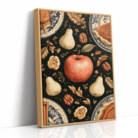 A Table Laid Before Dusk, a dark still life pattern of red apples, pale pears, walnuts and autumn leaves around pie plates, painted in charcoal, cream and rust, as a framed canvas in a natural wood frame