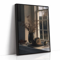 Afternoon Held in the Glass, a vase of dried branches on a sunlit sill reflected in a dark window pane, painted in soft umber, dusky sage and warm cream, as a framed canvas in a black frame