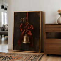 Bell Ringing for the Quiet Hour, a brass bell tied with a burgundy satin ribbon and dried sprigs, on a near black ground, in a wood frame on a wall beside a walnut cabinet and an open doorway