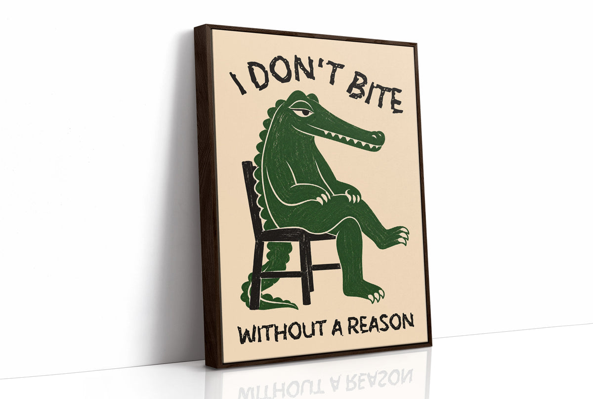 Bites Only With a Reason, a crocodile sitting upright in a plain wooden chair, in deep green on a cream ground, with a bold lettered line above reading I DON'T BITE and one below reading WITHOUT A REASON, as a framed canvas in a brown frame