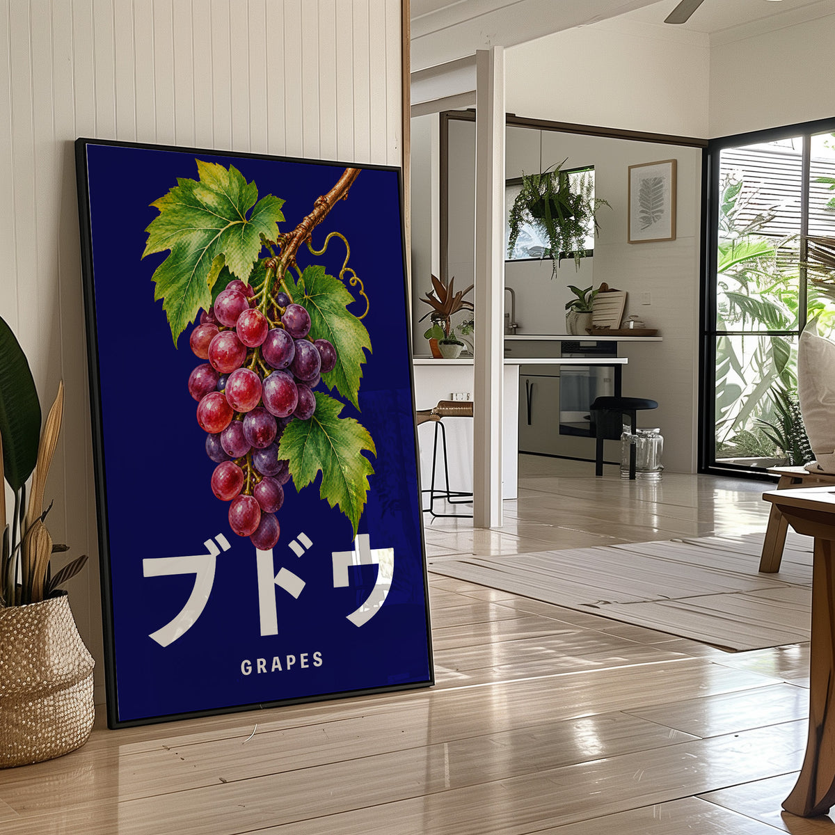 Clusters Heavy Over Midnight Water, a cluster of rose and purple grapes with green leaves hanging from a stem on a deep navy ground, with the Japanese katakana set in large white letters and the word GRAPES in small capitals beneath, in a black frame leaning on a bright hallway floor beside a potted plant