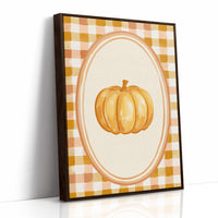 Dressed Up for a Quiet Afternoon, a single orange pumpkin in a cream oval medallion framed by a yellow and rust gingham border, painted in mustard, cream and burnt orange, as a framed canvas in a brown frame