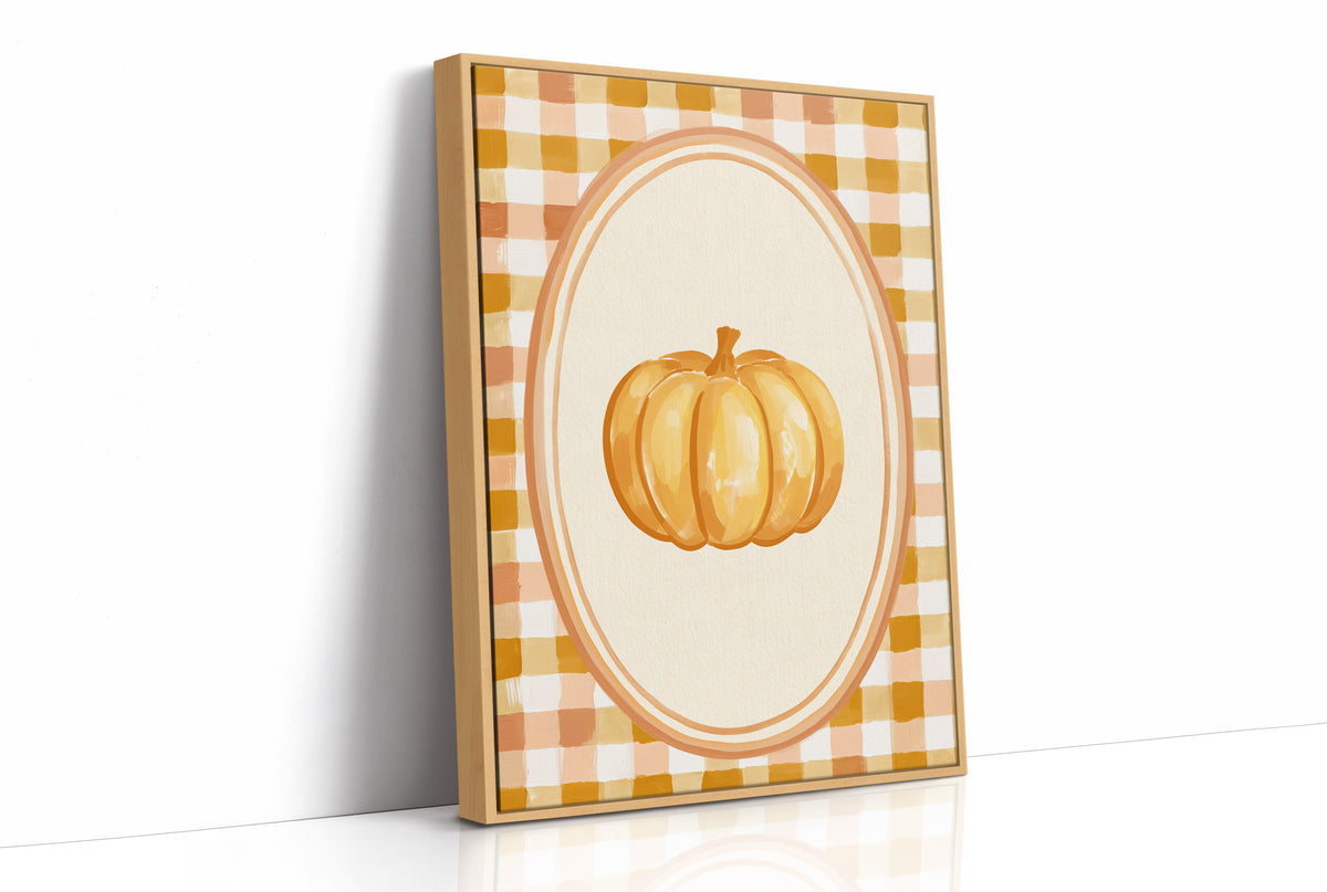 Dressed Up for a Quiet Afternoon, a single orange pumpkin in a cream oval medallion framed by a yellow and rust gingham border, painted in mustard, cream and burnt orange, as a framed canvas in a natural wood frame