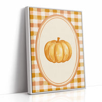 Dressed Up for a Quiet Afternoon, a single orange pumpkin in a cream oval medallion framed by a yellow and rust gingham border, painted in mustard, cream and burnt orange, as a framed canvas in a white frame