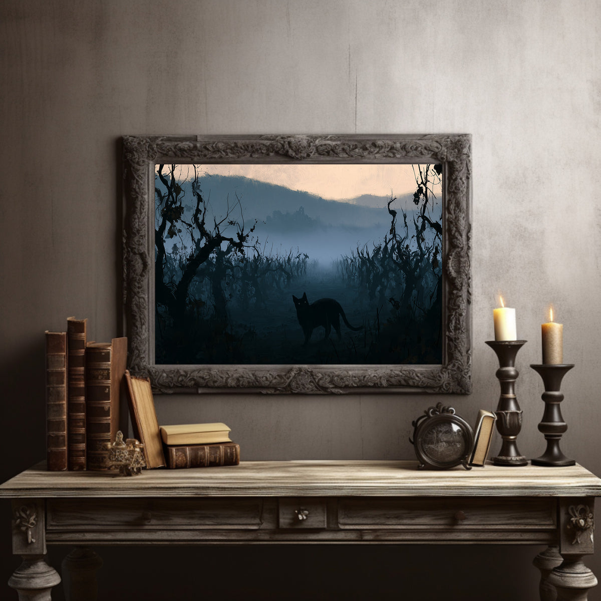 Dusk Keeps the Hollow Quiet, a black cat silhouette standing in misty hills under gnarled trees, peach sky band at dusk, blue and charcoal palette, in a dark carved frame on a gray wall above a console table with candlesticks and old books