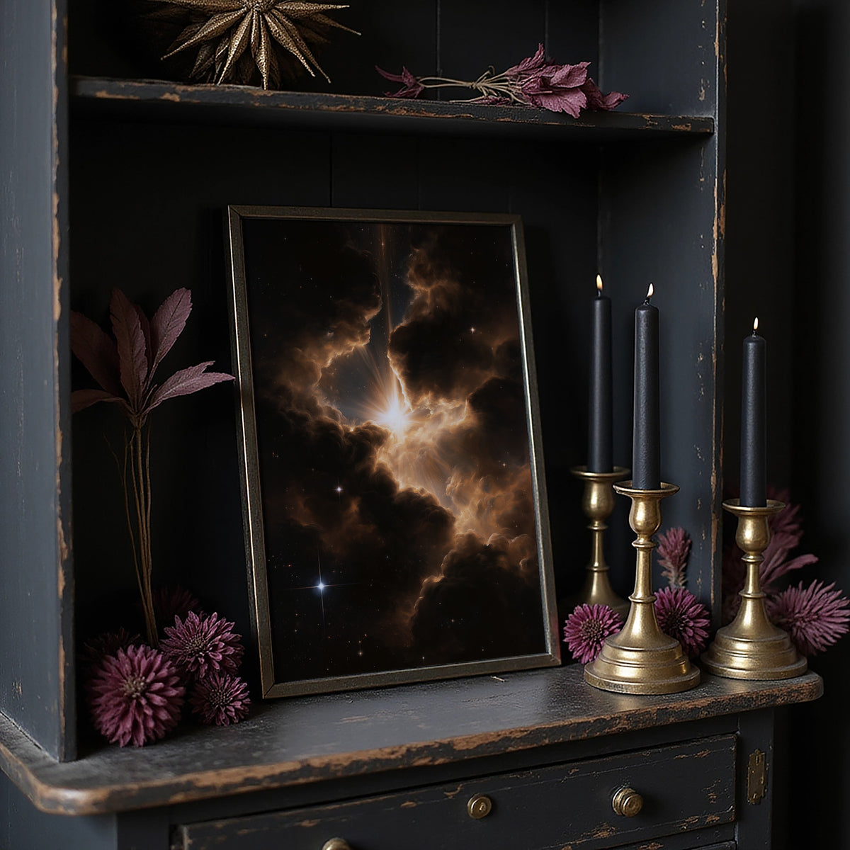 Embers Among the Cosmos, a nebula of gold and rust clouds glowing against a black sky dusted with small stars, painted in ember gold, umber and deep black, on a dark wooden cabinet shelf with candles and dried flowers