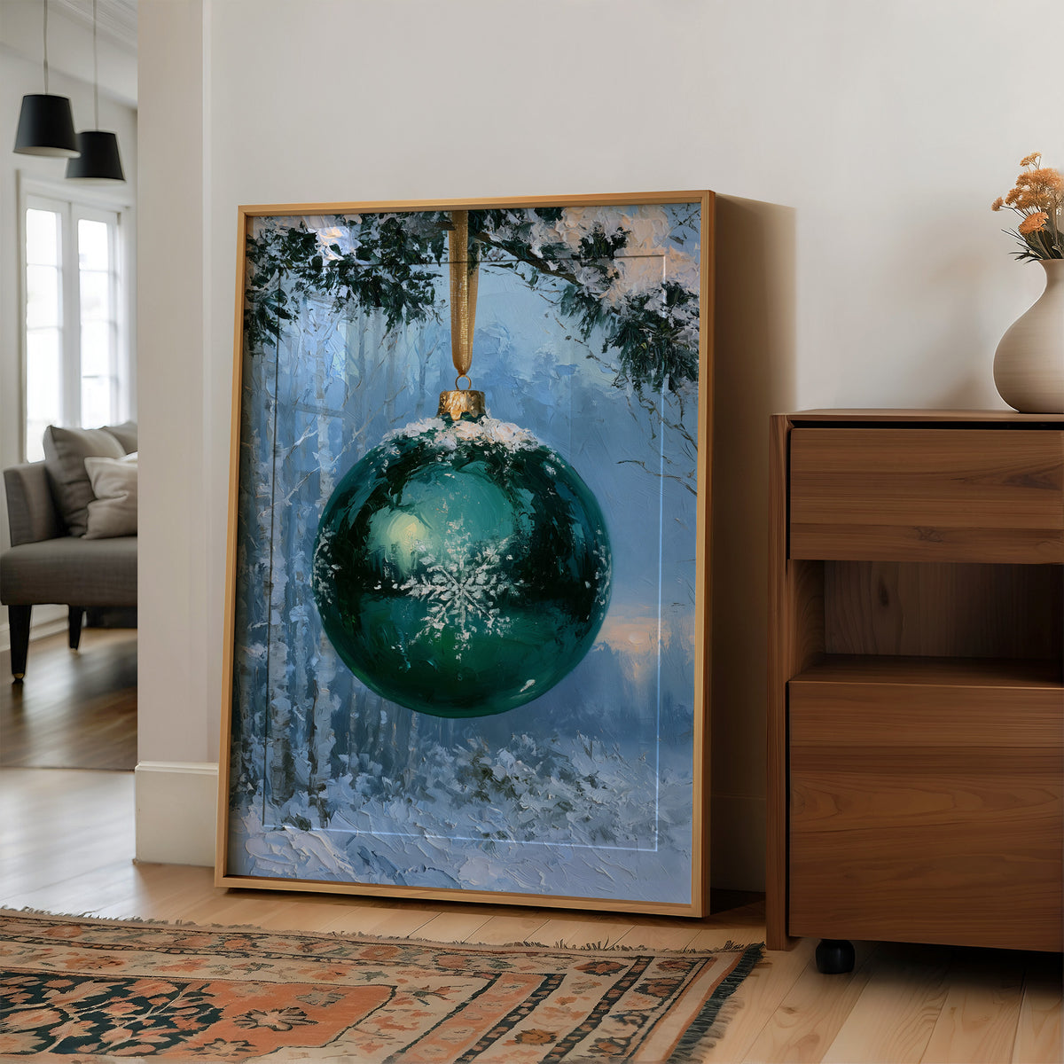 Emerald Light in the Snowlit Wood, a deep emerald glass bauble with a white snowflake on its face hangs from a gold cord in a snowy forest, with pale blue light and frosted pines behind, in a wood frame on a wall beside a walnut cabinet and an open doorway