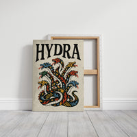 Every Head Grows Back Bolder, a many headed serpent with blue, red and gold scales rising in fans of heads, in a bold flash sheet style with a black lettered name across the top on a cream ground, on a gallery canvas with wrapped edges leaning against a white wall