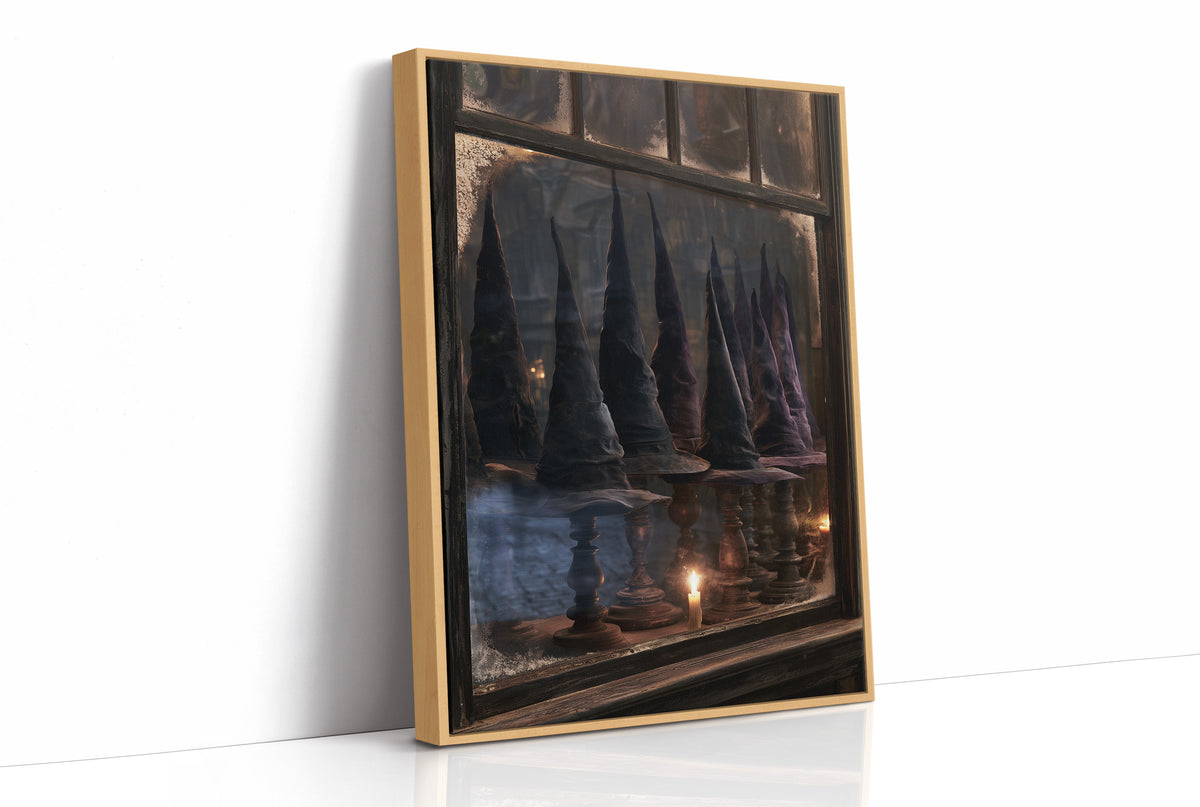Fitted for Midnight Flights, row of dark witch hats on wooden stands in a frosted shop window with a candle, as a framed canvas in a natural wood frame