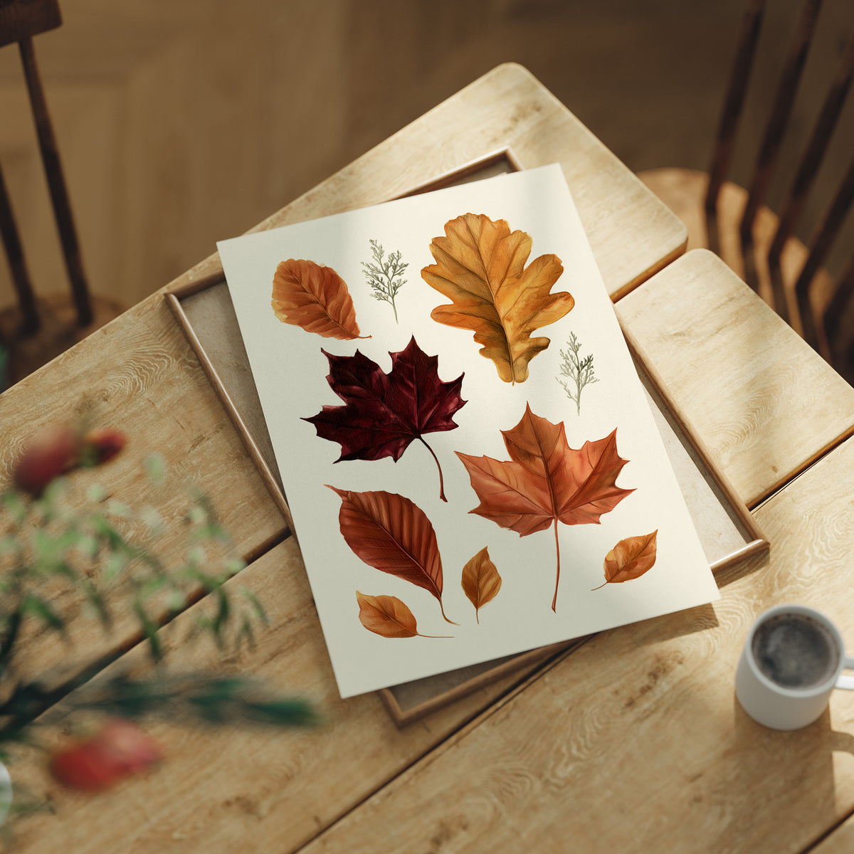 Gold Keeps Its Shape, a cluster of pressed autumn leaves in rust, maroon and gold on a cream ground, drawn in a botanical journal style, lying flat on a light wood table beside a coffee cup and red berries
