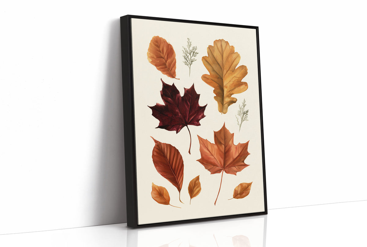 Gold Keeps Its Shape, a cluster of pressed autumn leaves in rust, maroon and gold on a cream ground, drawn in a botanical journal style, as a framed canvas in a black frame