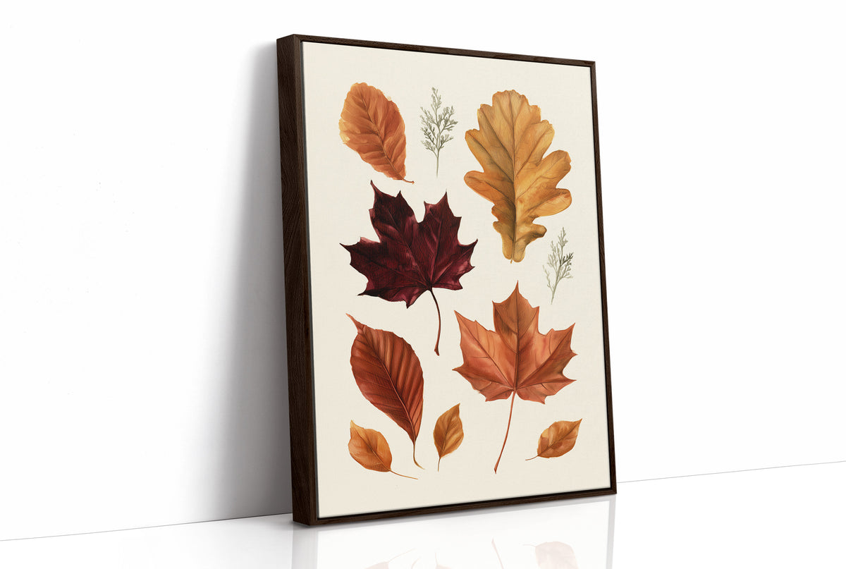 Gold Keeps Its Shape, a cluster of pressed autumn leaves in rust, maroon and gold on a cream ground, drawn in a botanical journal style, as a framed canvas in a brown frame