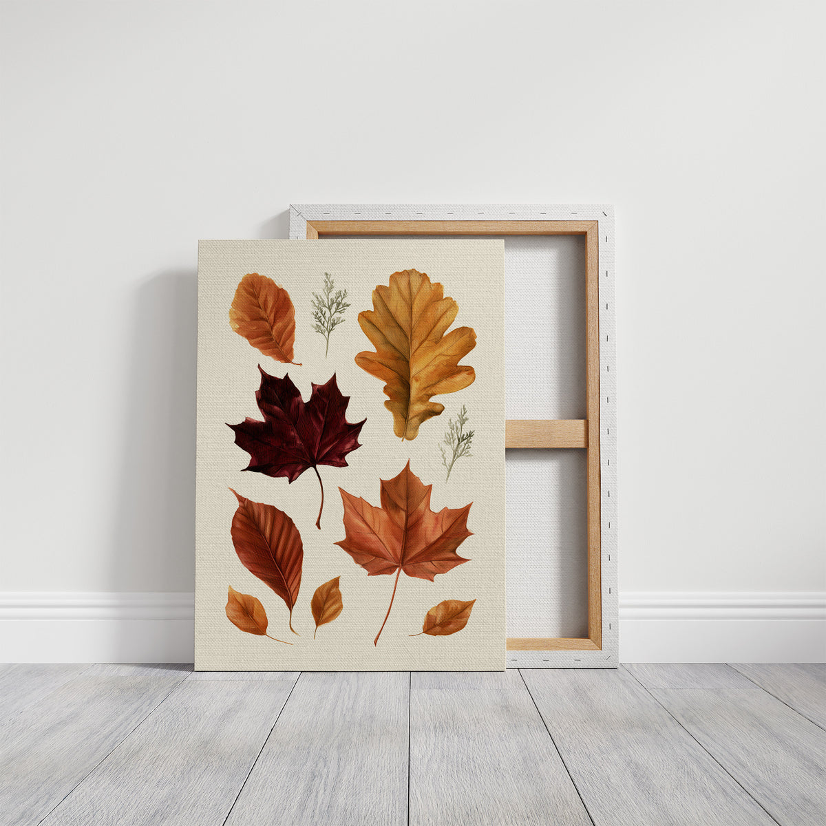 Gold Keeps Its Shape, a cluster of pressed autumn leaves in rust, maroon and gold on a cream ground, drawn in a botanical journal style, on a gallery canvas with wrapped edges leaning against a white wall