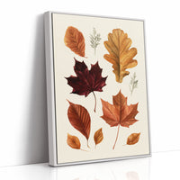 Gold Keeps Its Shape, a cluster of pressed autumn leaves in rust, maroon and gold on a cream ground, drawn in a botanical journal style, as a framed canvas in a white frame
