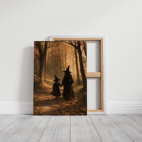 Hand in Hand Through the Woods, two witches in pointed hats walking hand in hand down a path through an autumn forest, one tall and one small, painted in gold, rust and deep shadow, on a gallery canvas with wrapped edges leaning against a white wall