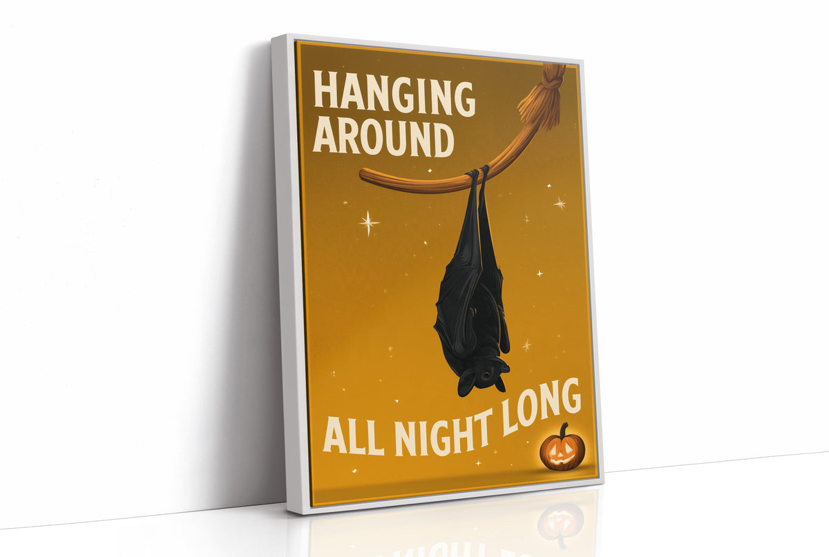 Hanging Around All Night Long, mustard yellow bat illustration with bold cream lettering, as a framed canvas in a white frame