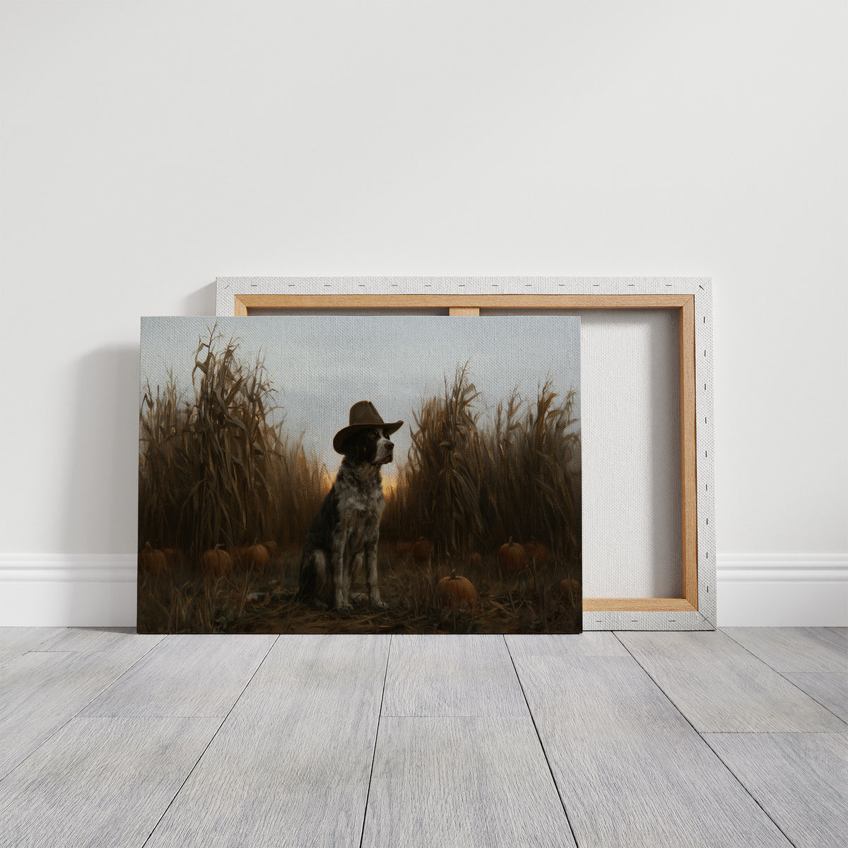 He Guards the Corn Until Dusk, a spotted dog wearing a cowboy hat, sitting in a cornfield among pumpkins under a pale gray evening sky, on a gallery canvas with wrapped edges leaning against a white wall