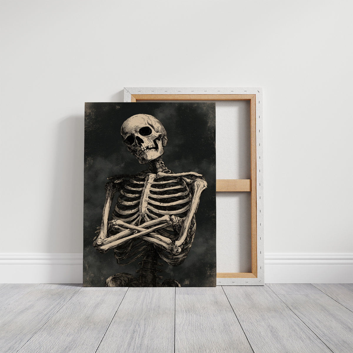 He Keeps His Arms Folded, a seated skeleton with crossed arms and bare ribs against a smoky charcoal ground, painted in bone, charcoal and ash gray, on a gallery canvas with wrapped edges leaning against a white wall
