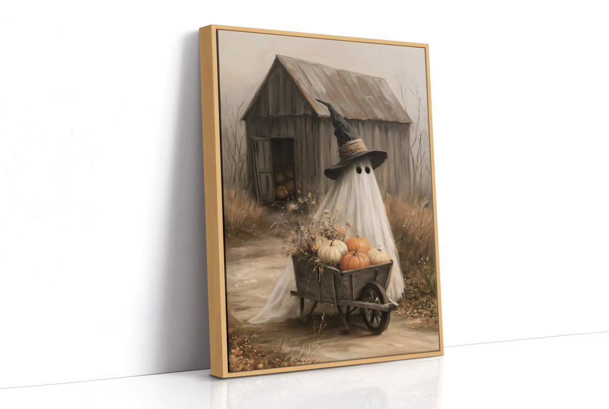 Just Passing Through, Boo, a ghost in a witch hat pushing a wheelbarrow of pumpkins past a weathered shed, painted in straw, gray and pale white, as a framed canvas in a natural wood frame