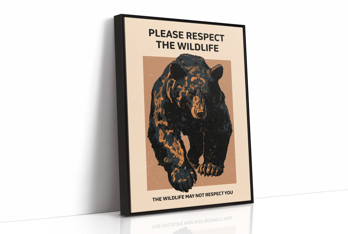Keep a Respectful Distance, a large black bear with amber and brown fur, head low and shoulders bunched, set on a tan ground under bold black lettering that reads PLEASE RESPECT THE WILDLIFE in a vintage warning sign style, as a framed canvas in a black frame