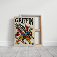 Keeper of the Gilded Gate, a winged lion guardian with a golden body, red and blue feathers and a black lettered name across the top, in a bold flash sheet style on cream parchment, on a gallery canvas with wrapped edges leaning against a white wall