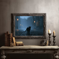 Lamplight Along the Cobbled Road, a black cat walking a cobbled lane between lamp posts in blue fog, twisted trees at the edges, moody night scene, in a dark carved frame on a gray wall above a console table with candlesticks and old books