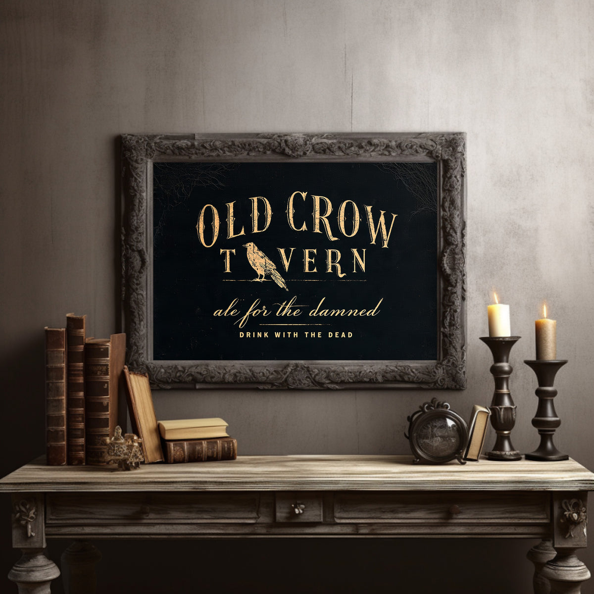 Last Call for the Restless, a black tavern sign lettered in gold with a perched golden bird, painted in black, oxblood and antique gold, in a dark carved frame on a gray wall above a console table with candlesticks and old books