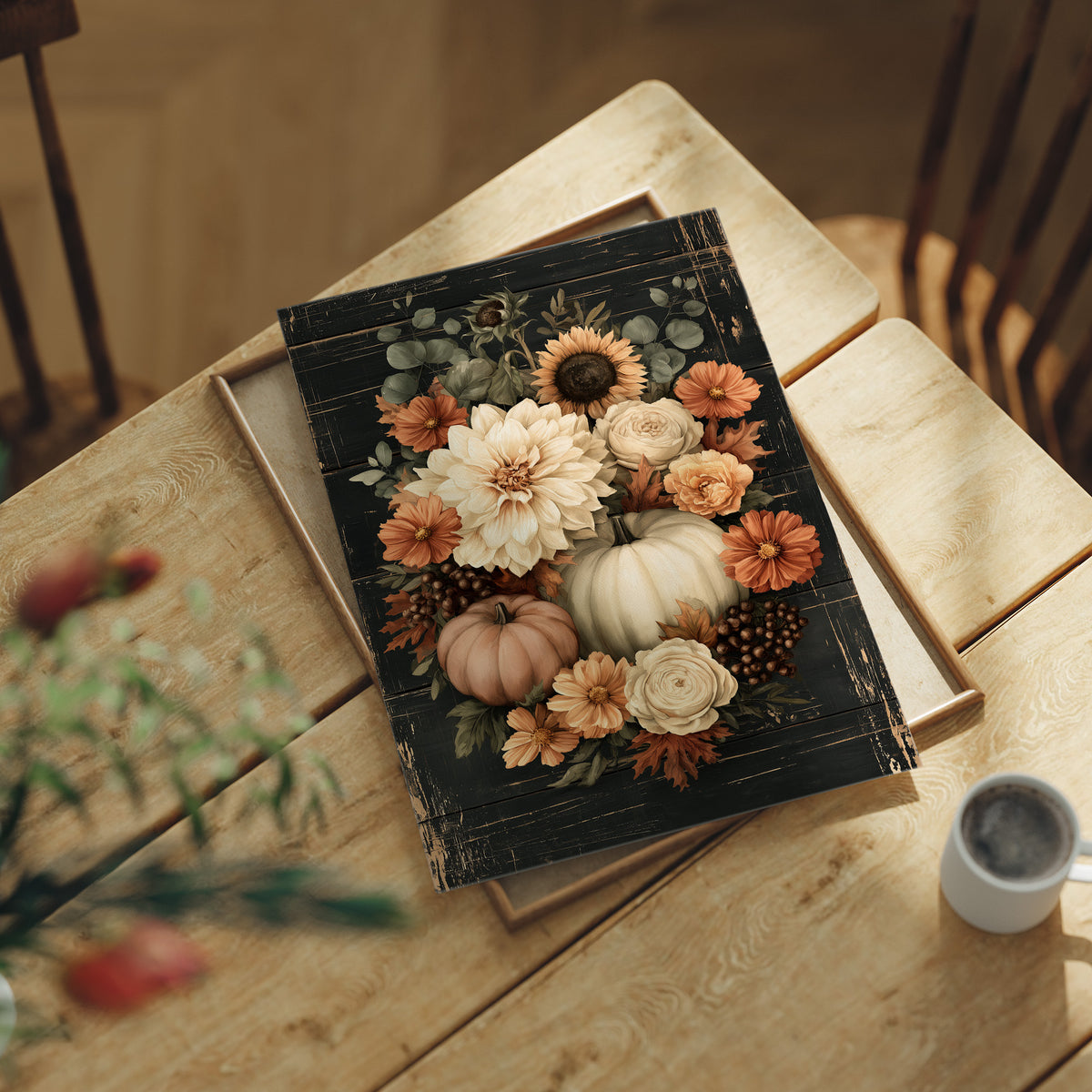 Late Blooms Remember the Harvest, a dark floral bouquet of dahlias, cream roses and small pumpkins with eucalyptus, painted in cream, rust and burnt orange on a black ground, lying flat on a light wood table beside a coffee cup and red berries