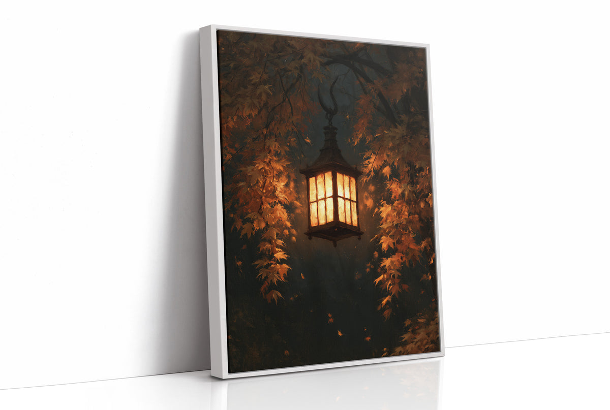 Left On for Someone, a glowing iron lantern hanging in a dark thicket of rust and amber leaves, painted in deep brown, ember orange and warm gold, as a framed canvas in a white frame