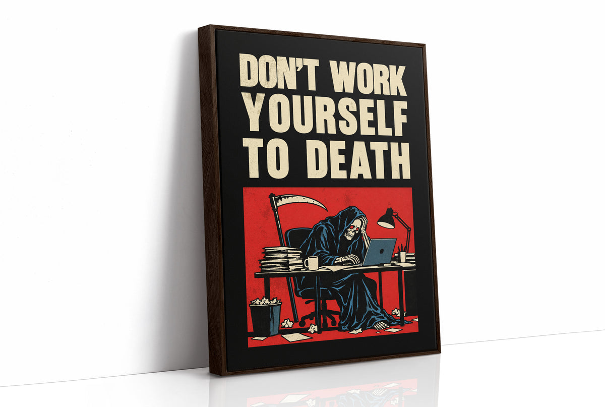 Let the Inbox Wait Till Monday, a hooded reaper hunched over a cluttered desk with a laptop and a stack of files, in a red panel with the lettering DON'T WORK YOURSELF TO DEATH in heavy cream capitals on black, as a framed canvas in a brown frame