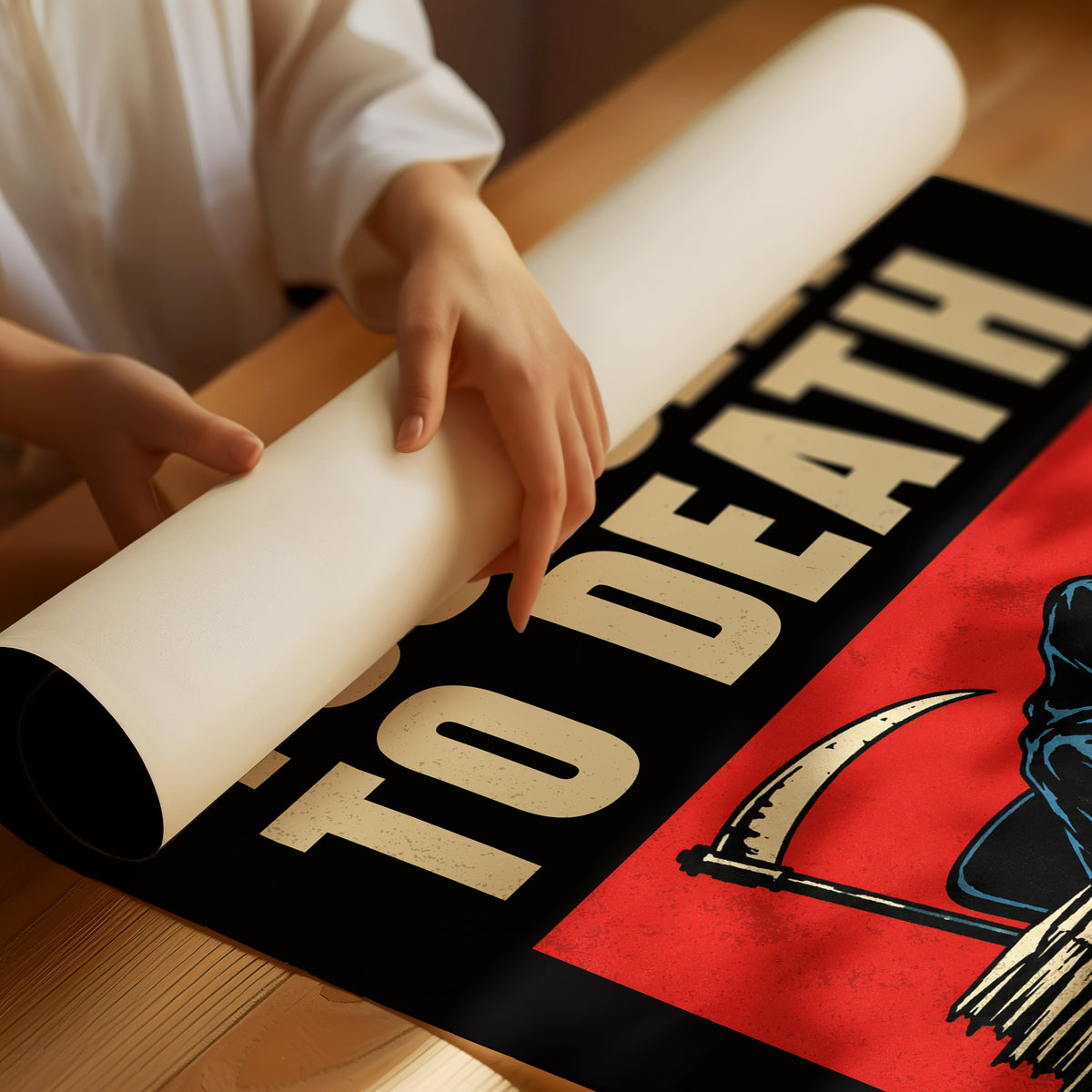 Let the Inbox Wait Till Monday, a hooded reaper hunched over a cluttered desk with a laptop and a stack of files, in a red panel with the lettering DON'T WORK YOURSELF TO DEATH in heavy cream capitals on black, as a matte poster, unframed