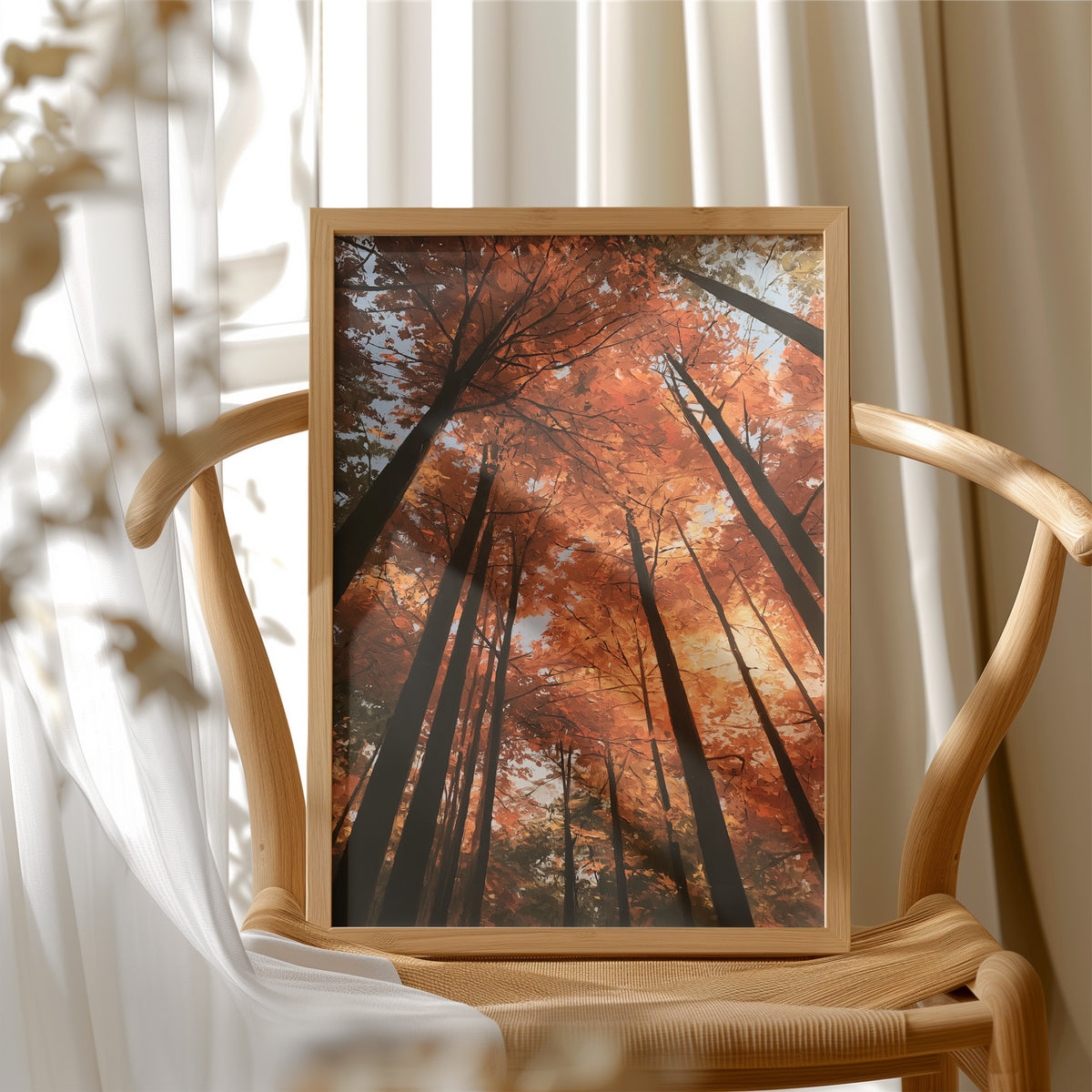 Look Up Into the Burning Wood, looking straight up through a canopy of tall dark trunks and orange autumn foliage, the pale sky glowing behind them, painted in rust, burnt orange and charcoal, in a wood frame beside a wicker chair by a sunny window